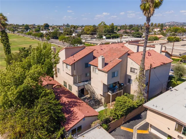 an aerial view of residential houses with outdoor space and swimming pool