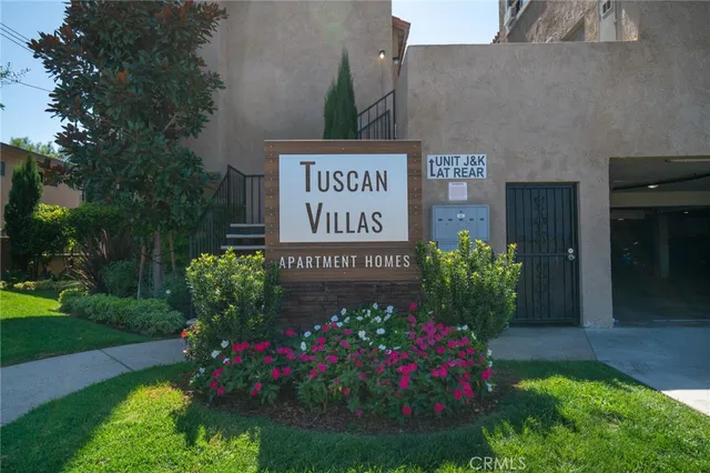 a sign that is in front of flowers