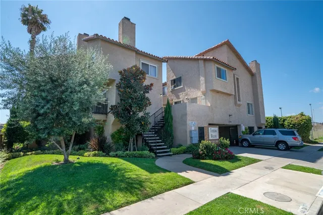 a front view of a house with a yard and trees