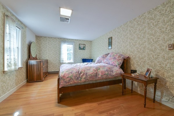 33 R Cedar Street Wellesley, MA 02481 - Photo 11 of 21 a bedroom with a bed and wooden floor