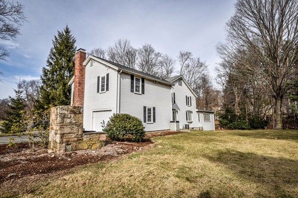 33 R Cedar Street Wellesley, MA 02481 - Photo 21 of 21 a view of a white house next to a yard with big trees