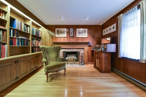 33 R Cedar Street Wellesley, MA 02481 - Photo 5 of 21 a living room with furniture a fireplace and a bookshelf