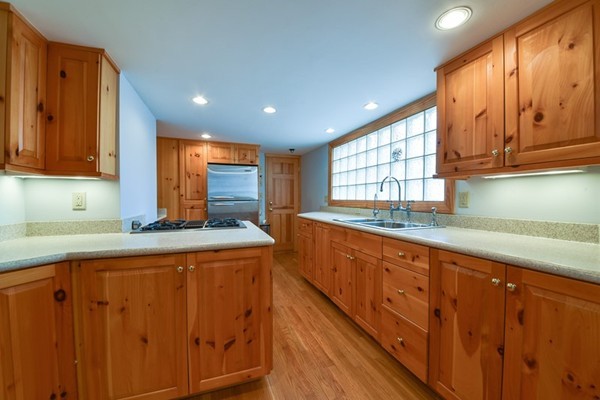 33 R Cedar Street Wellesley, MA 02481 - Photo 8 of 21 a kitchen with stainless steel appliances granite countertop wooden cabinets a sink and dishwasher