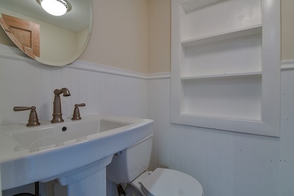 33 R Cedar Street Wellesley, MA 02481 - Photo 9 of 21 a bathroom with a sink mirror and toilet