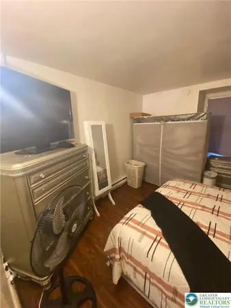 a bedroom with a bed and a desk