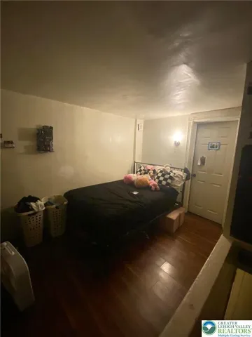 a view of a hallway with wooden floor and closet