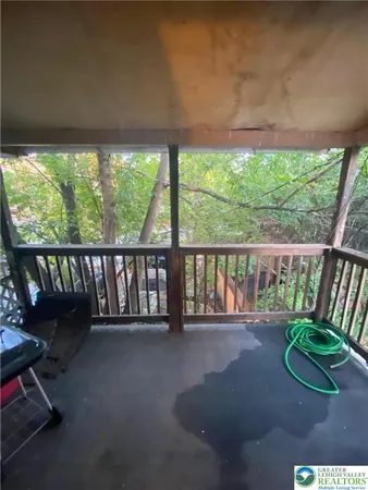 a view of porch with a small yard