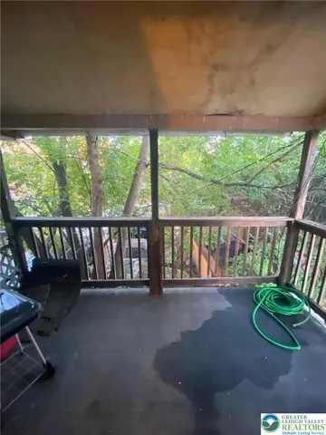 a view of porch with a small yard