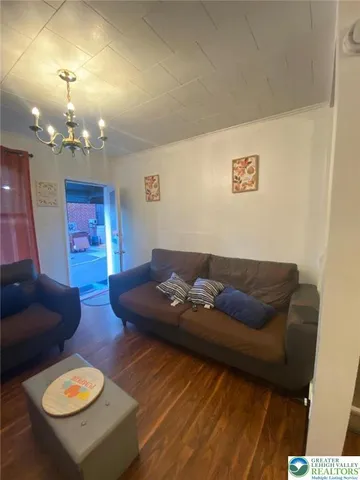 a living room with furniture and a dining table