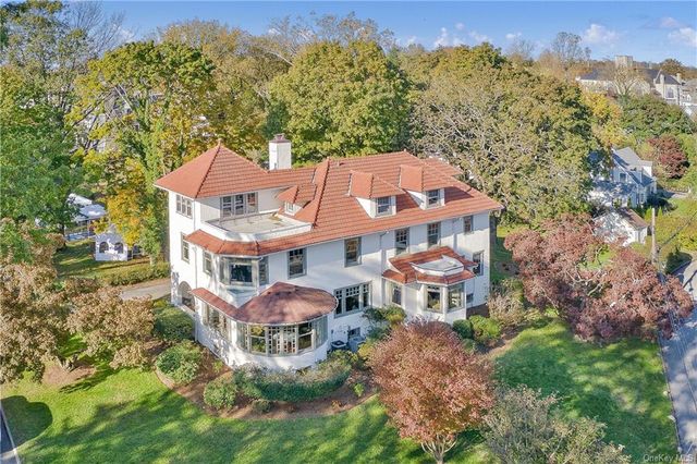 an aerial view of a house with a yard