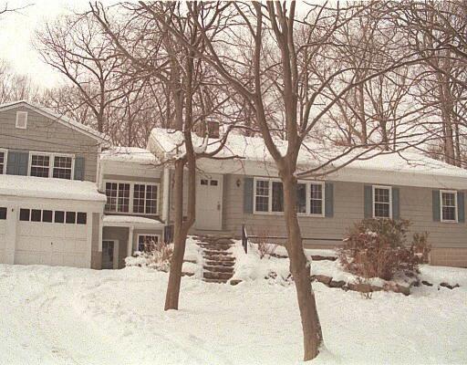 241 Old Boston Road Wilton, CT 06897 - Photo 1 of 1 a front view of a house with a yard covered in snow