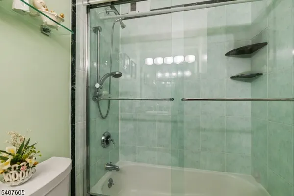 a bathroom with a shower and a bath tub