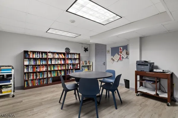 a view of a work space with furniture and wooden floor