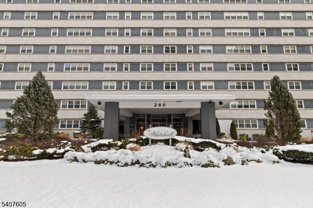 a front view of a building with parking space