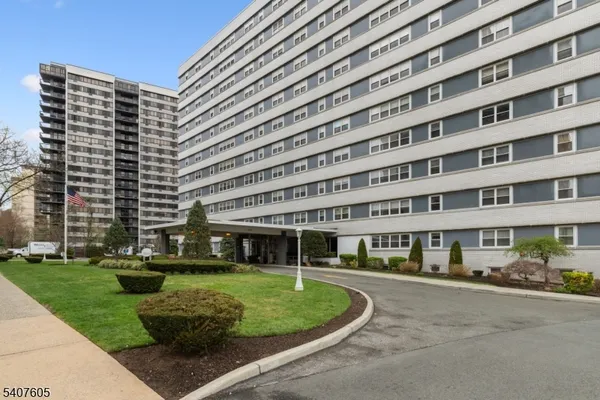 a front view of a building with a garden