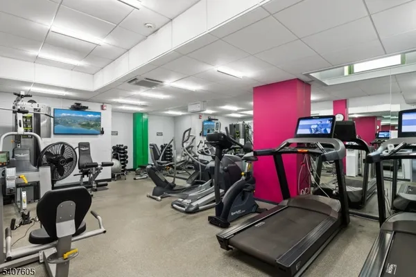 a room with gym equipment and windows
