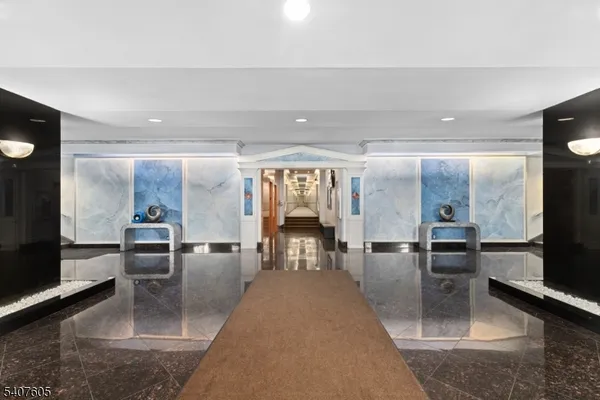 a lobby with furniture and flat screen tv