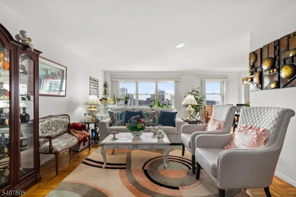 a living room with furniture fireplace and a large window