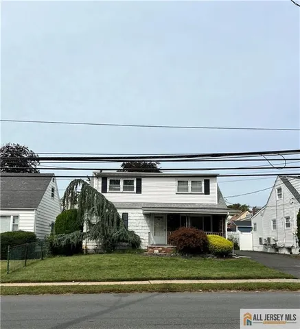a view of house with a yard and potted plants
