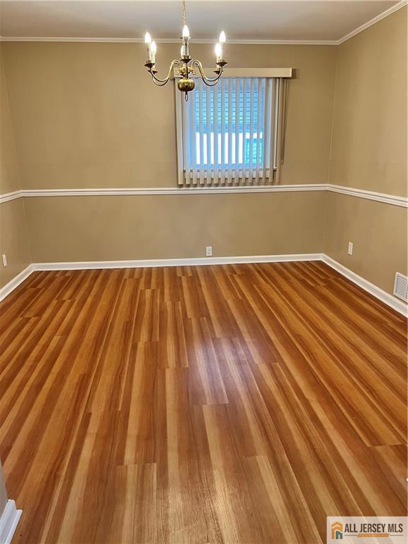 3257 Washington Road Sayreville, NJ 08859 - Photo 4 of 16 a view of room with wooden floor and chandelier