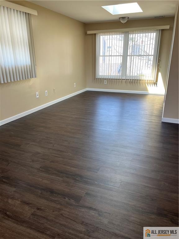 3257 Washington Road Sayreville, NJ 08859 - Photo 8 of 16 an empty room with wooden floor and windows