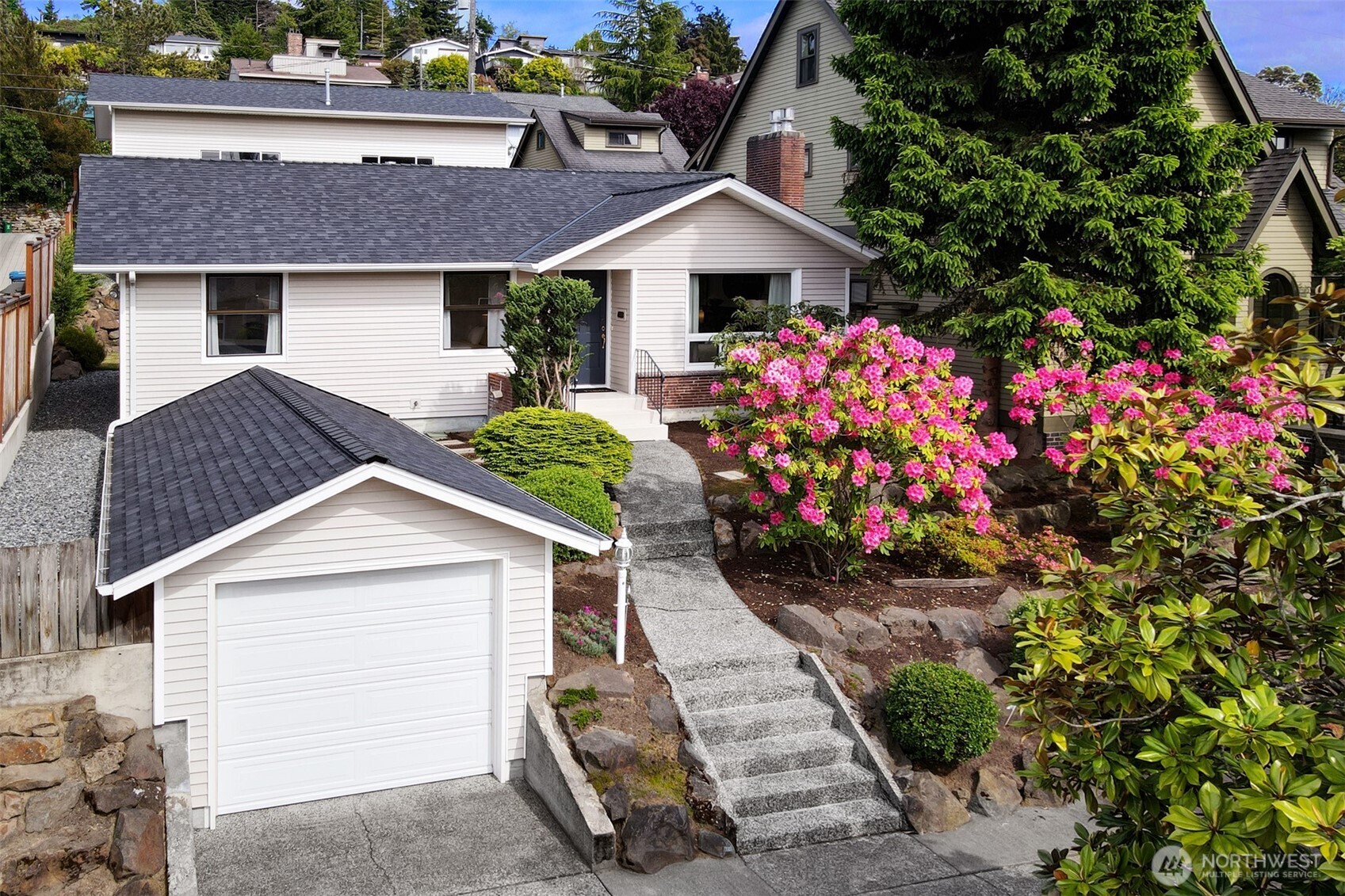 a front view of a house with a yard and fountain