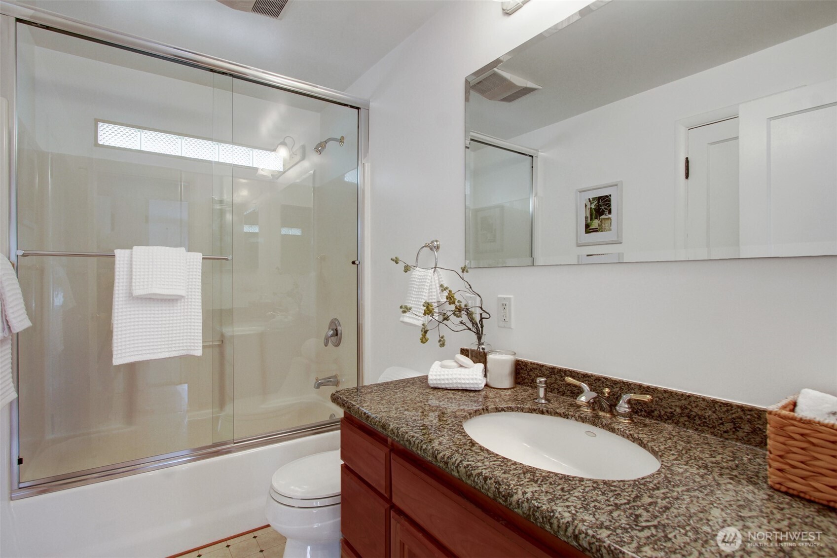 3236 32nd Avenue West Seattle, WA 98199 - Photo 13 of 33 a bathroom with a granite countertop sink a toilet a mirror and shower