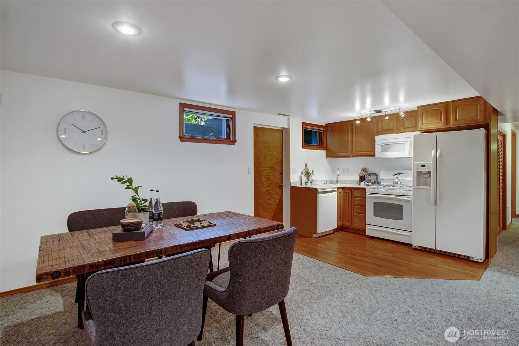 3236 32nd Avenue West Seattle, WA 98199 - Photo 15 of 33 a kitchen with stainless steel appliances a stove a refrigerator a sink with a dining table and chairs
