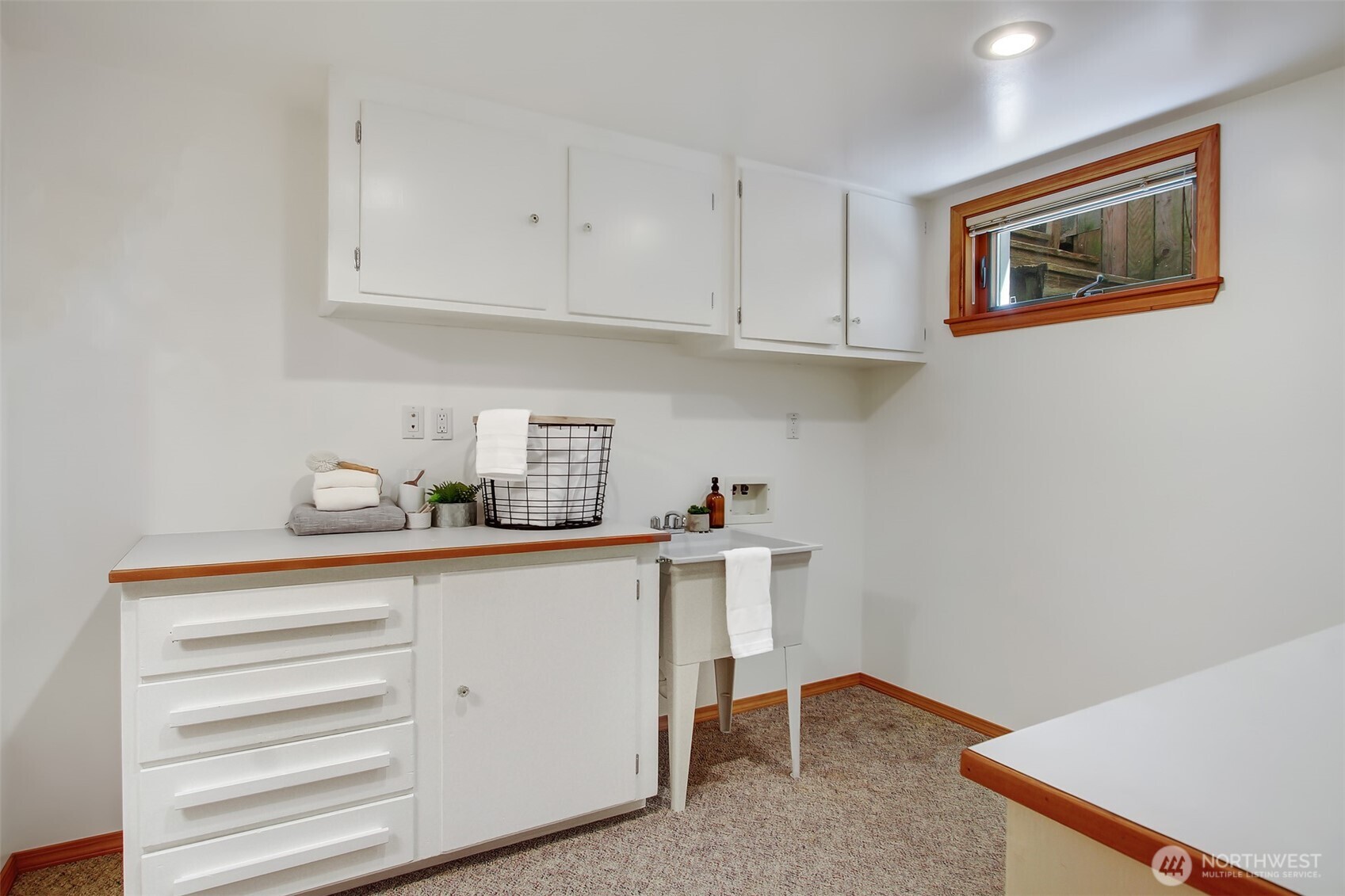 3236 32nd Avenue West Seattle, WA 98199 - Photo 20 of 33 a view of cabinets a sink and dishwasher in a kitchen