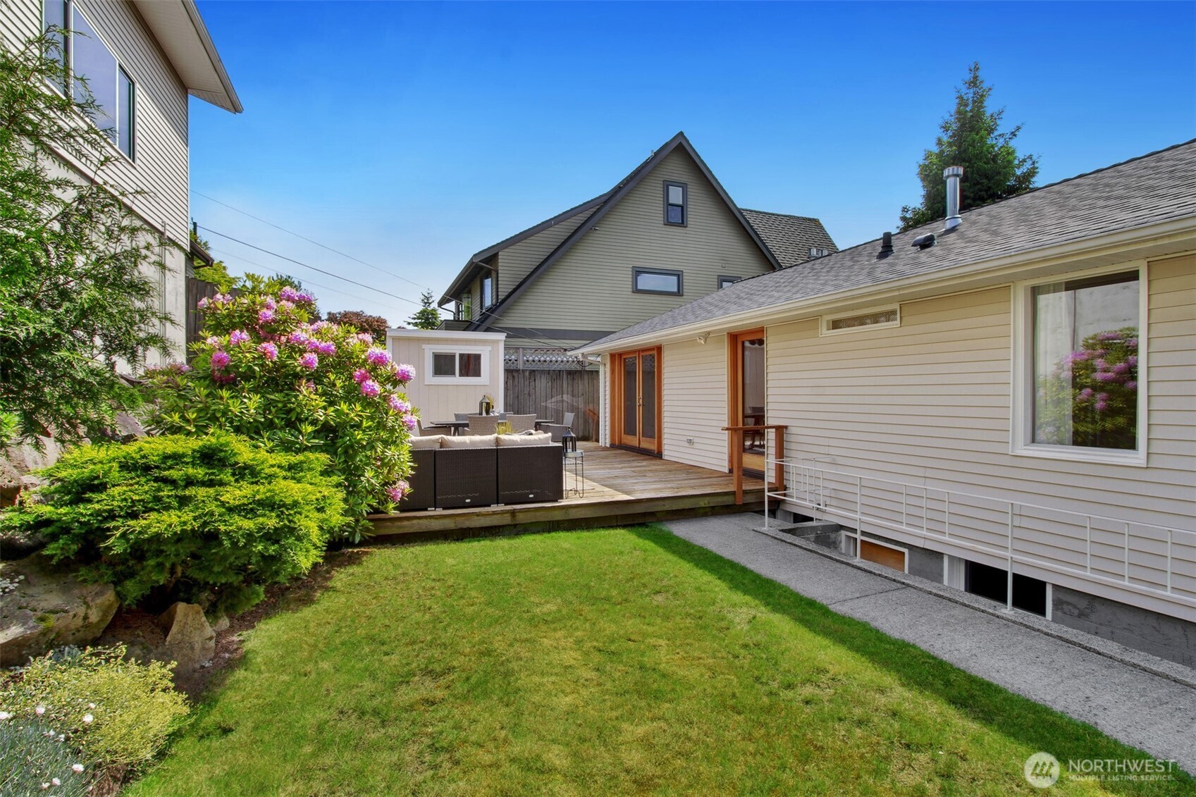 3236 32nd Avenue West Seattle, WA 98199 - Photo 22 of 33 a view of a house with a yard and sitting area