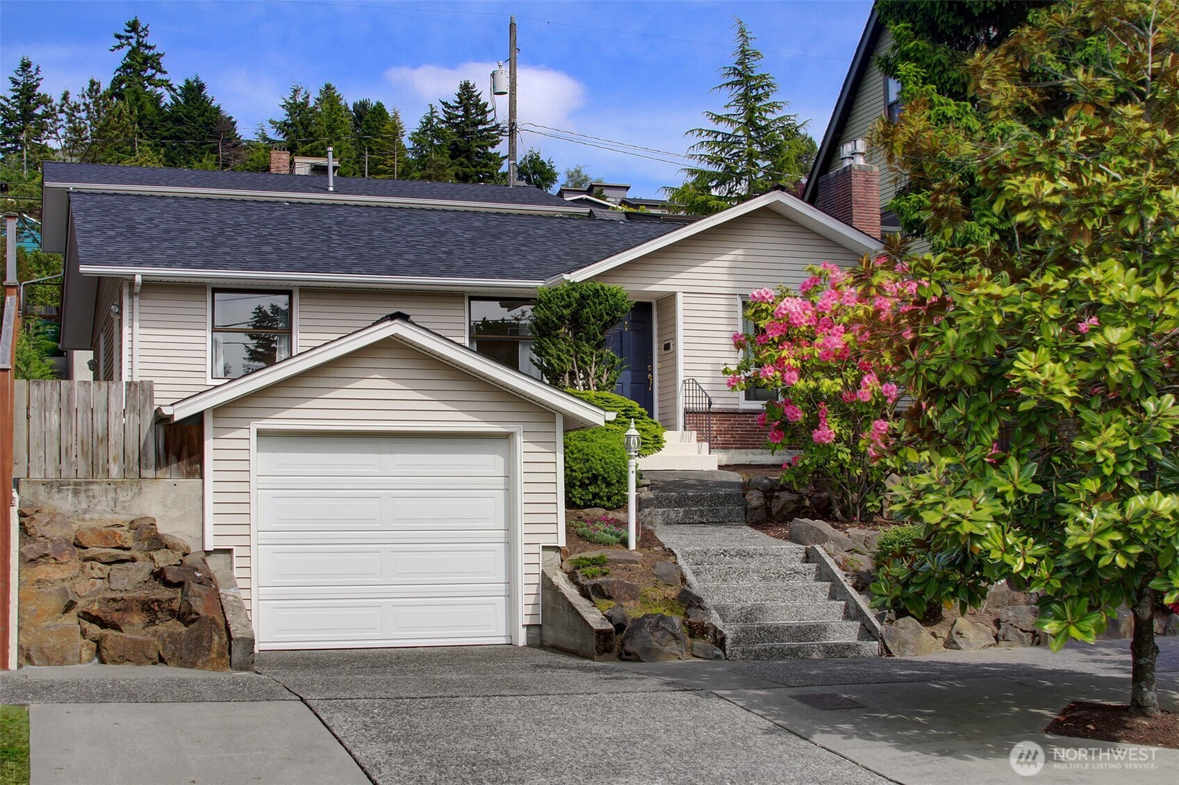3236 32nd Avenue West Seattle, WA 98199 - Photo 28 of 33 a front view of a house with a yard and garage