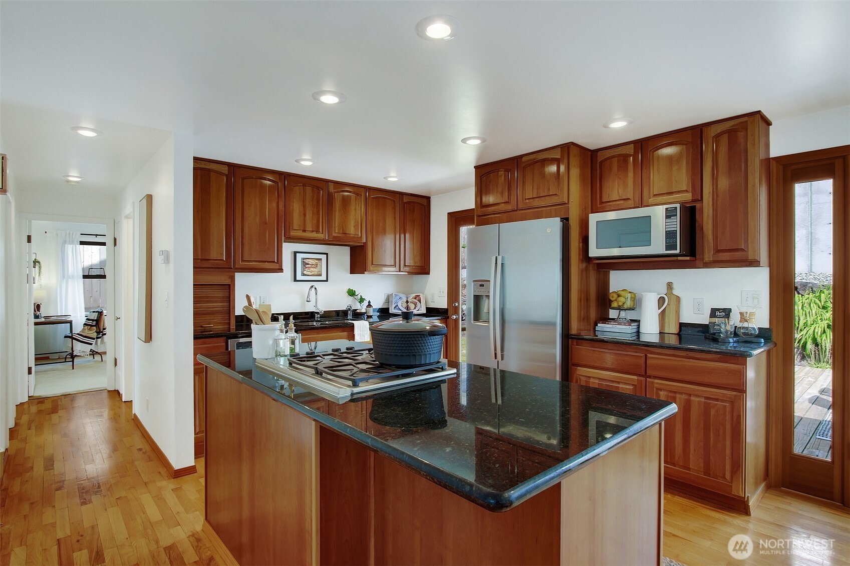 3236 32nd Avenue West Seattle, WA 98199 - Photo 6 of 33 a kitchen with stainless steel appliances granite countertop a refrigerator a stove top oven a sink and dishwasher