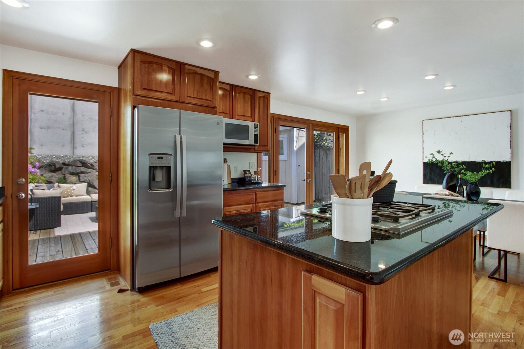 3236 32nd Avenue West Seattle, WA 98199 - Photo 7 of 33 a kitchen with stainless steel appliances granite countertop a refrigerator a sink and a stove