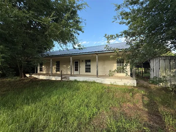 a view of a house with swimming pool and sitting area