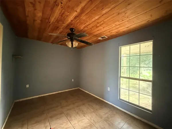 a view of a livingroom with a ceiling fan and window