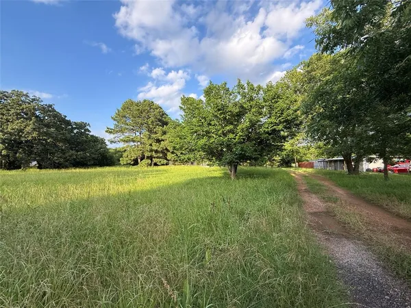 a bathroom with a granite countertop sink a mirror and a shower