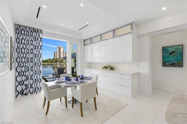 a kitchen with a dining table chairs and window