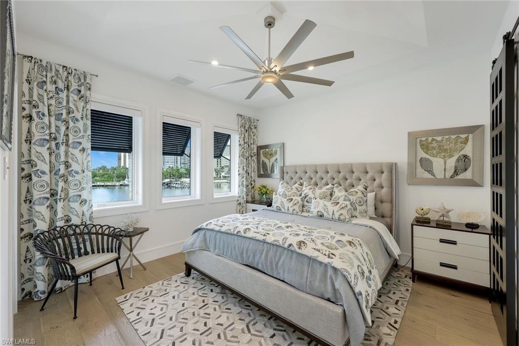 309 Neapolitan Way Naples, FL 34103 - Photo 24 of 33 a bedroom with a large bed and a window