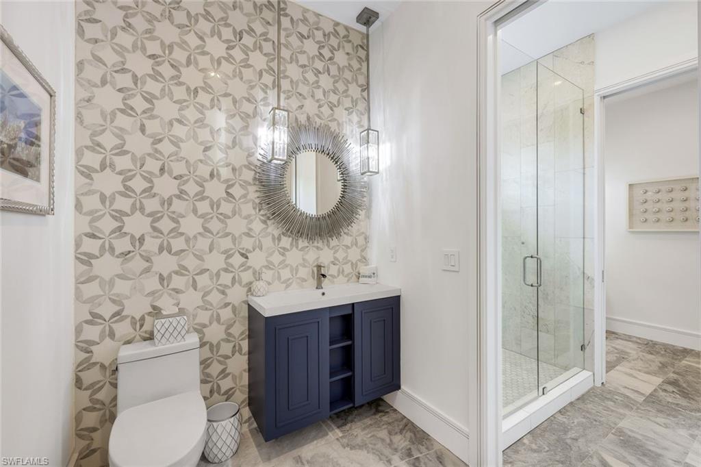 309 Neapolitan Way Naples, FL 34103 - Photo 27 of 33 a bathroom with a toilet and a sink