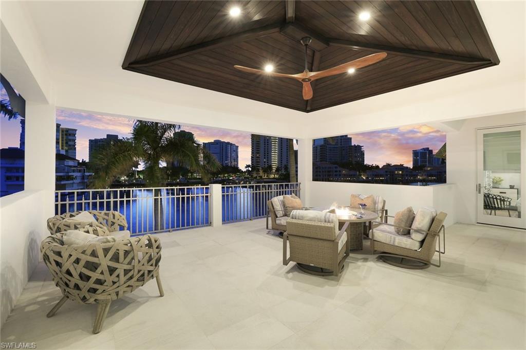 309 Neapolitan Way Naples, FL 34103 - Photo 31 of 33 a living room with furniture and a flat screen tv
