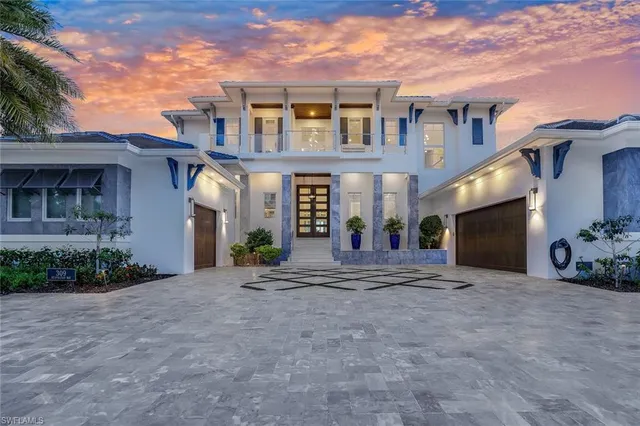 a front view of a house with a yard and a garage