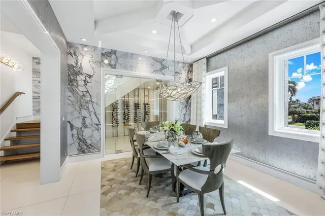 a view of a dining room with furniture and chandelier