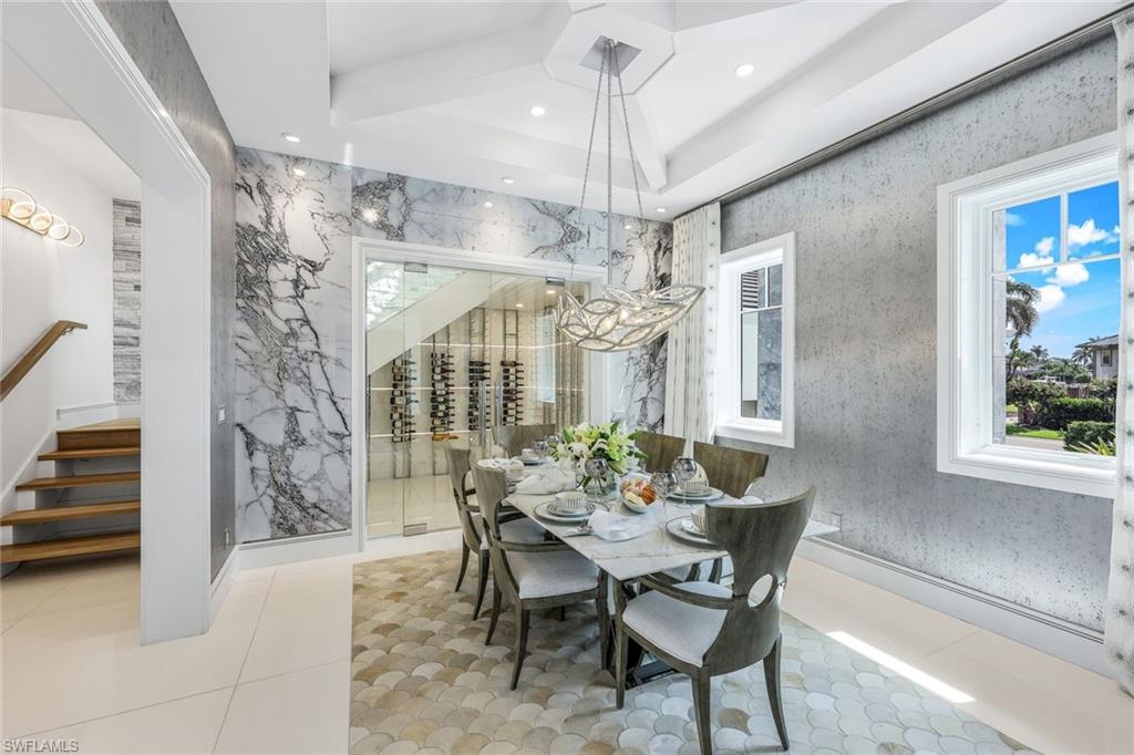 309 Neapolitan Way Naples, FL 34103 - Photo 8 of 33 a view of a dining room with furniture and chandelier