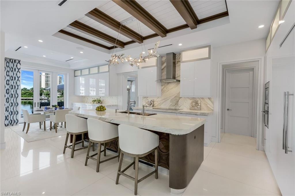 309 Neapolitan Way Naples, FL 34103 - Photo 9 of 33 a view of a dining room with furniture