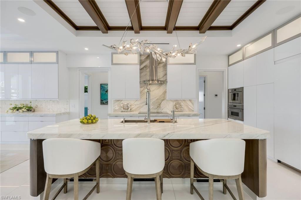 309 Neapolitan Way Naples, FL 34103 - Photo 10 of 33 a view of a dining room with furniture