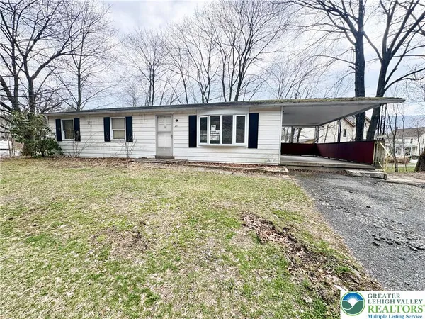 a house that has a tree in front of it