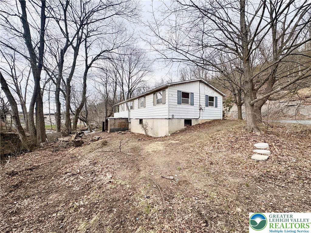 211 Fireline Road Bowmanstown, PA 18071 - Photo 3 of 13 a white house that has a tree in front of it