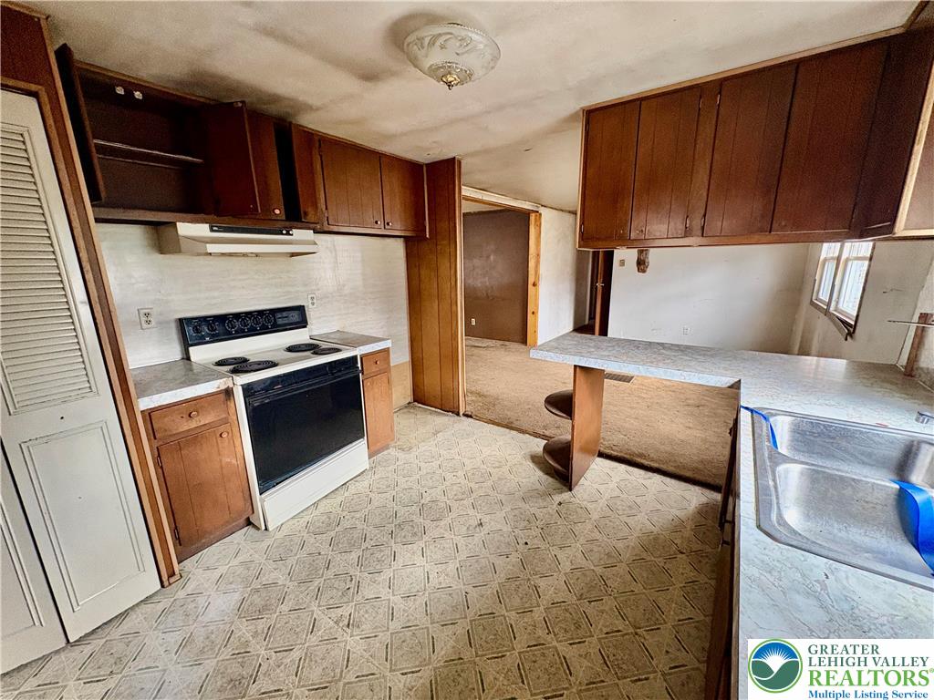 211 Fireline Road Bowmanstown, PA 18071 - Photo 6 of 13 a kitchen with stainless steel appliances a stove a refrigerator and a sink