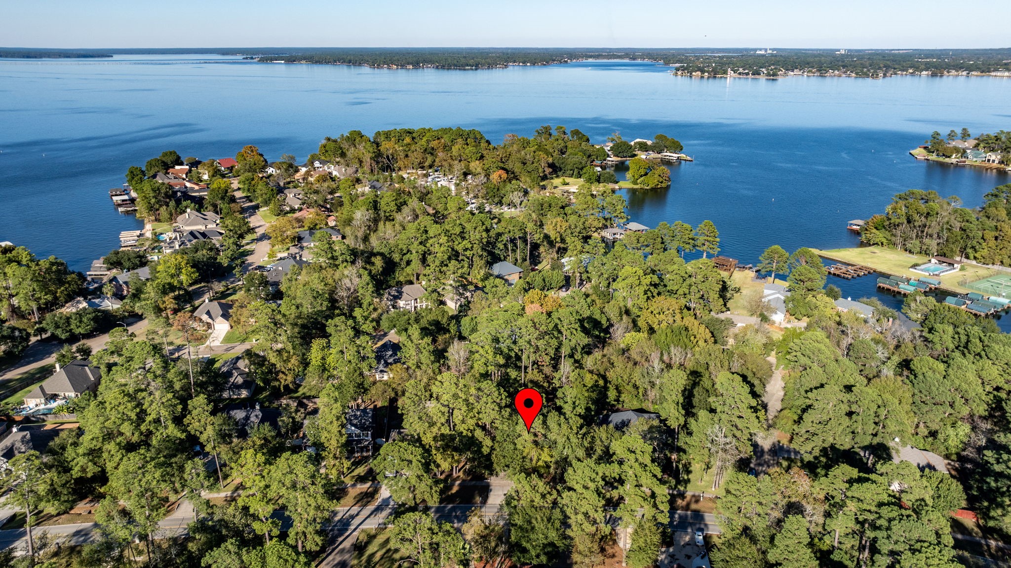 11506 Walden Road Montgomery, TX 77356 - Photo 44 of 50 a picture of a lake with a building in the background