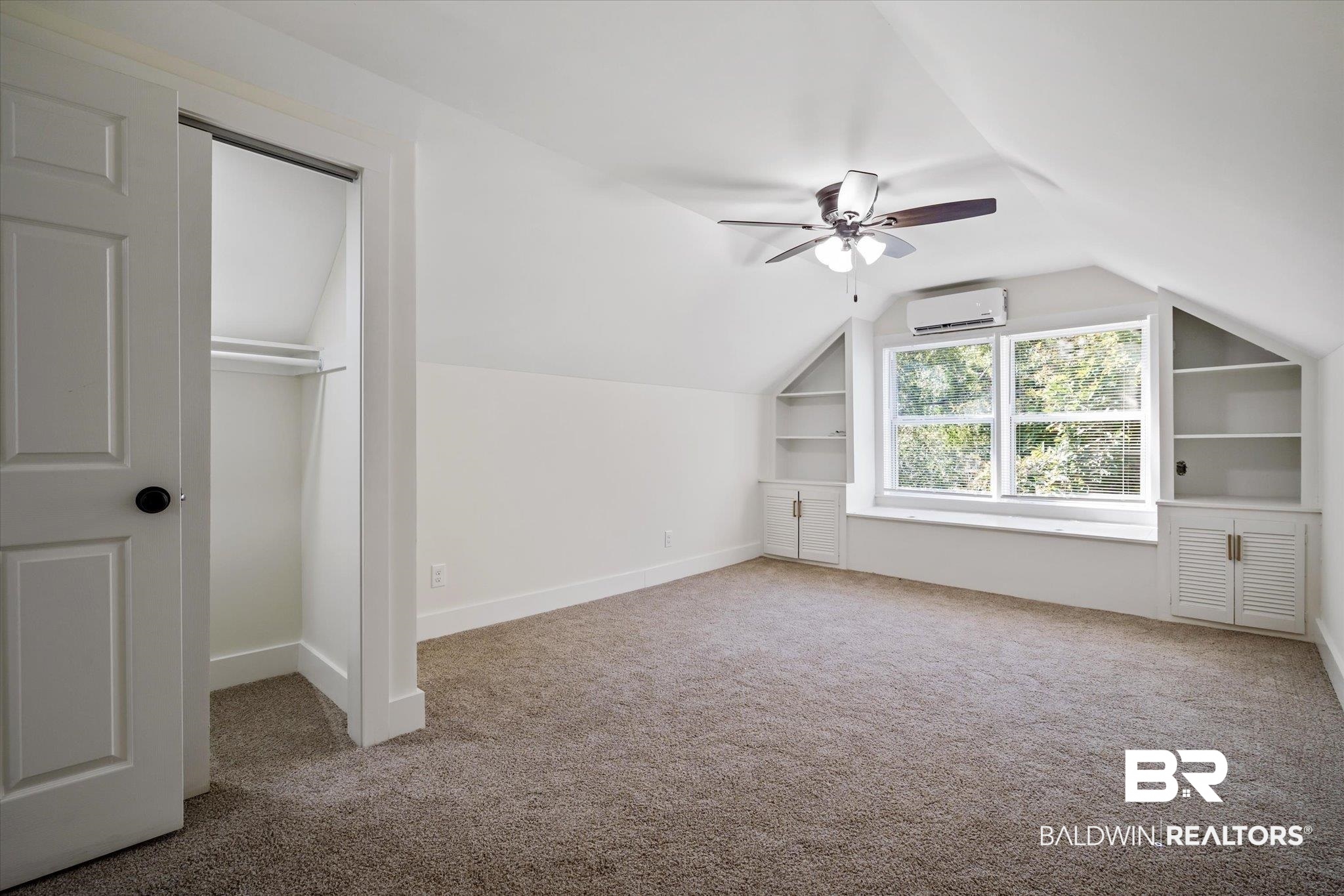 308 Byron Avenue West Mobile, AL 36609 - Photo 19 of 33 Bonus room featuring carpet floors, built in features, lofted ceiling, ceiling fan, and a wall unit AC